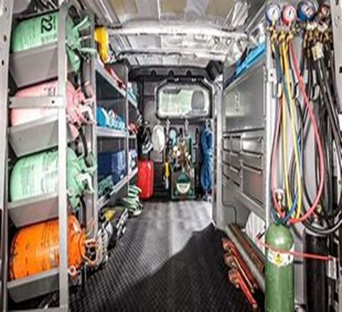 Utility van interior fitted with shelving and equipment storage